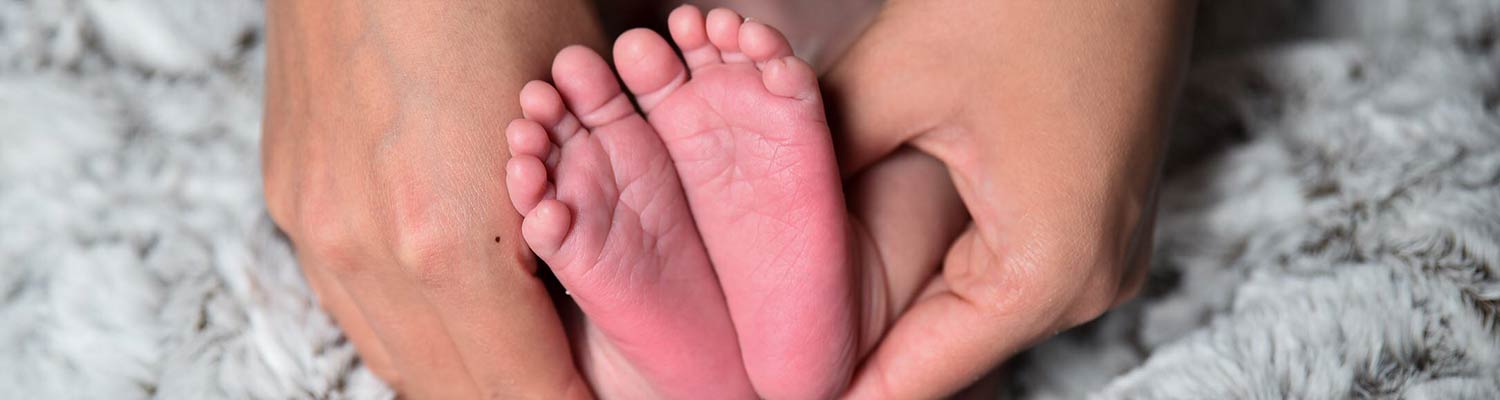 Hands holding baby's feet